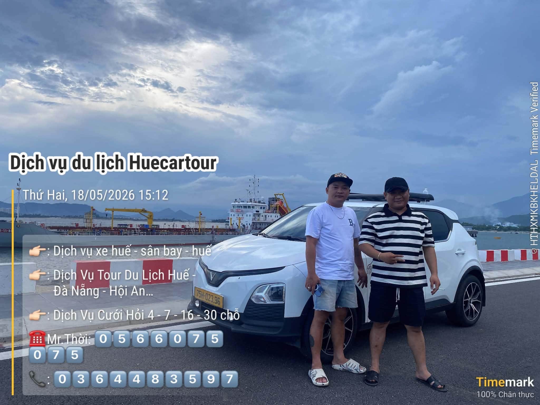 Thời standing beside his car at the port in Da Nang